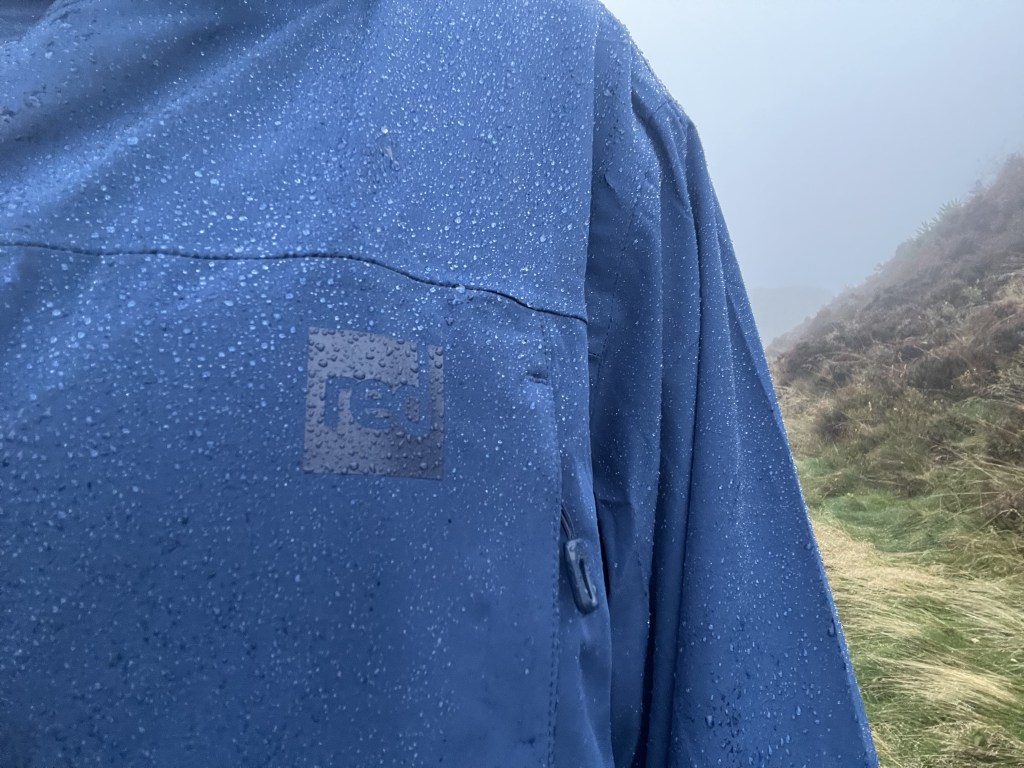 Peak District rain beading off the Red Equipment Pursuit Changing Robe. Credit: Francesca Donovan